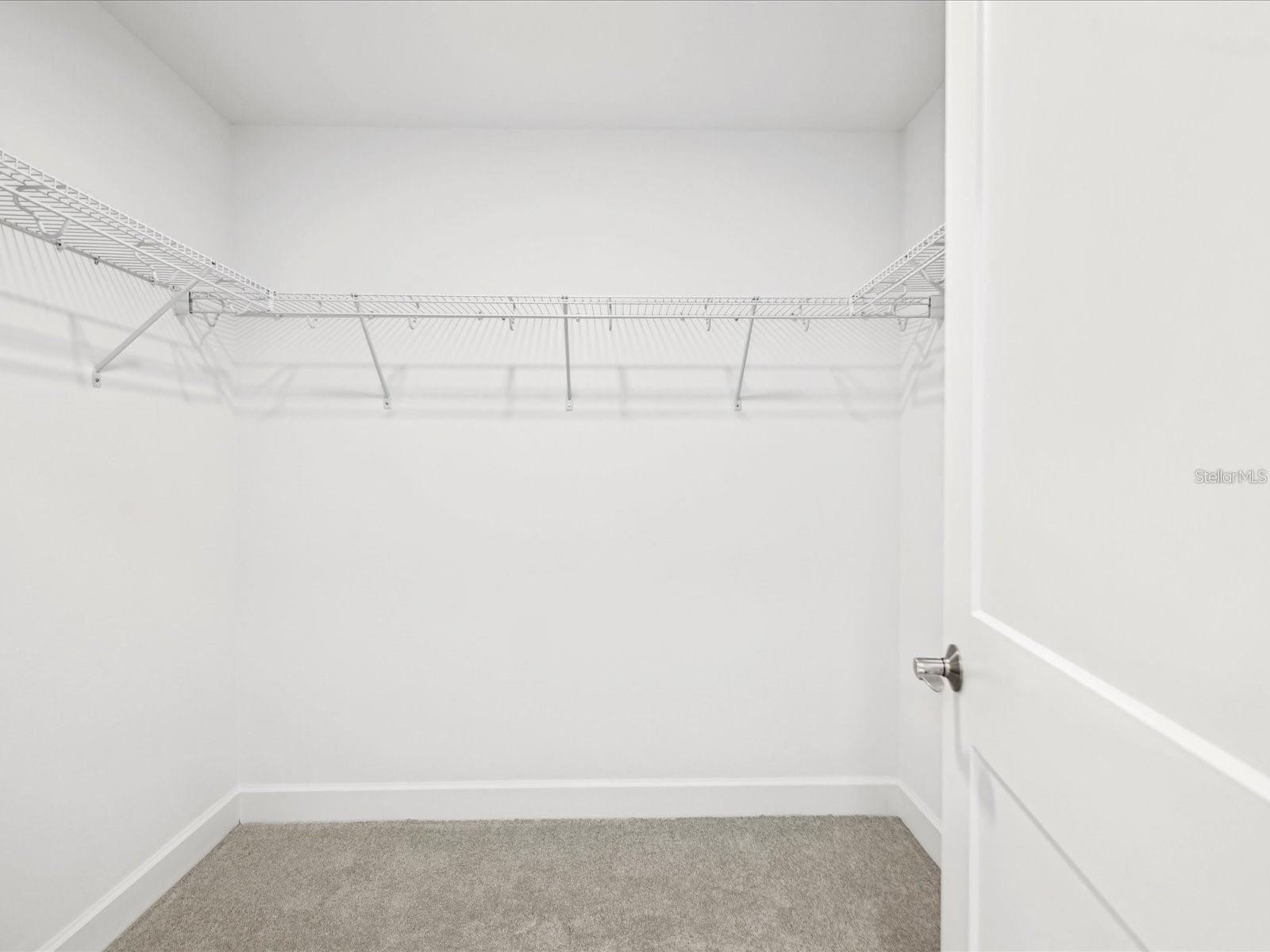 Primary Large walk in closet has many possibilities