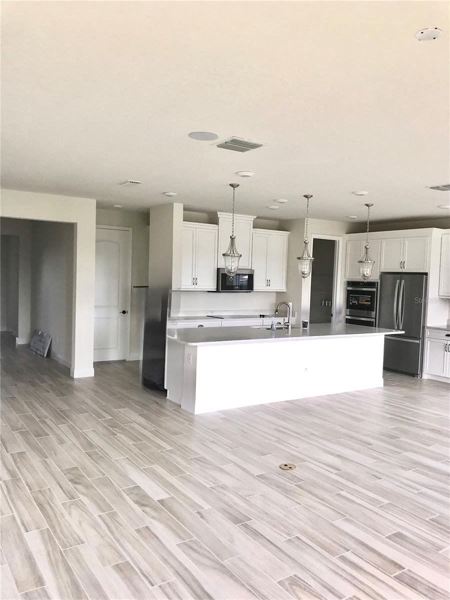 Unfurnished Kitchen with double sink and double oven