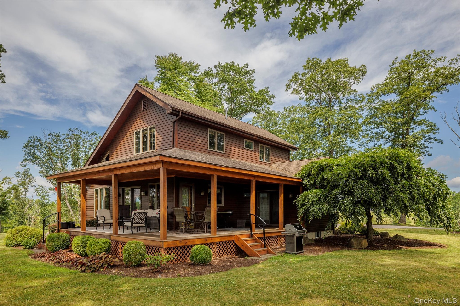 Rear view of property featuring a shingled roof and a yard