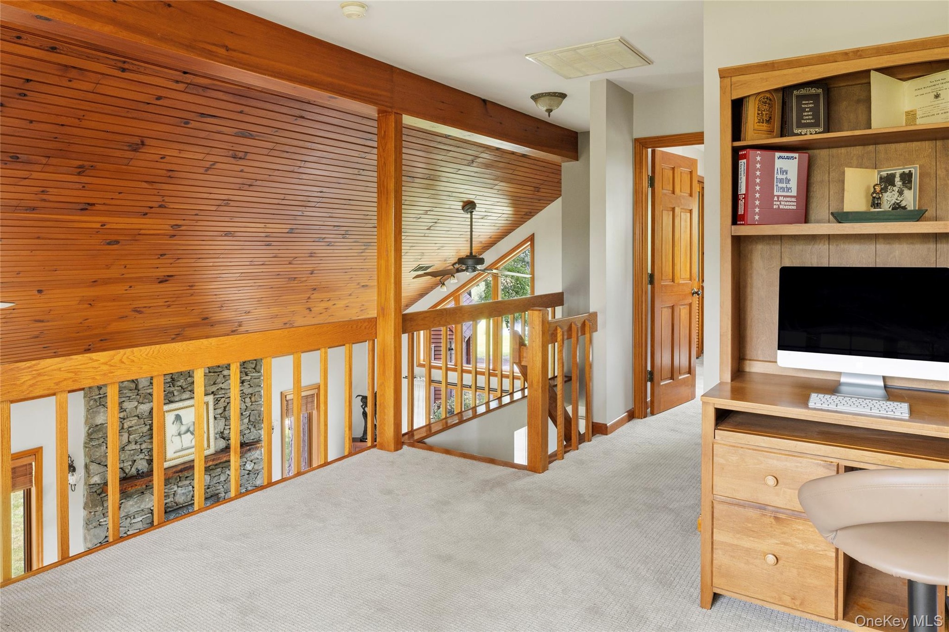 Home office featuring carpet flooring and ceiling fan