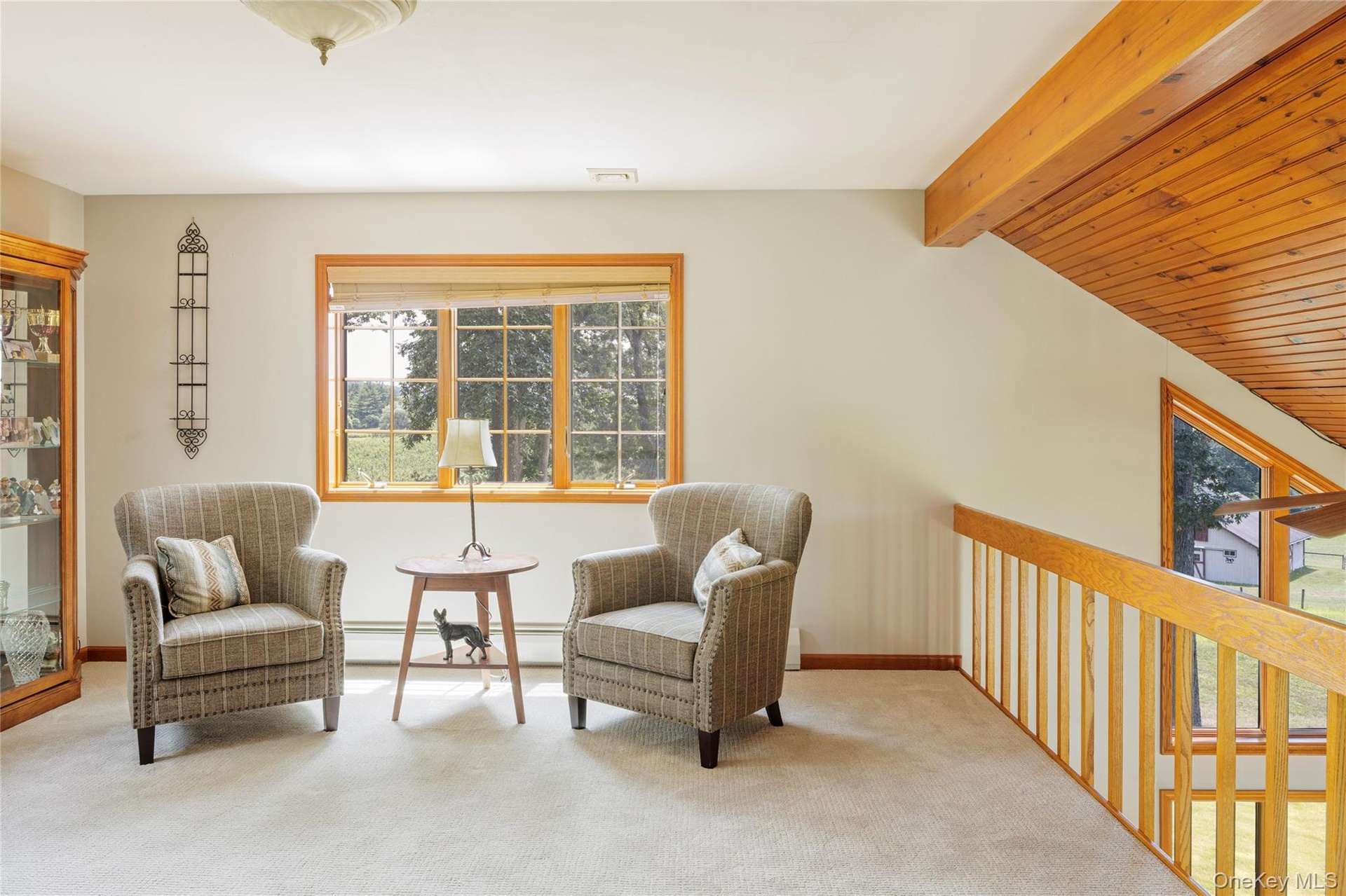 Sitting room featuring baseboard heating and carpet flooring