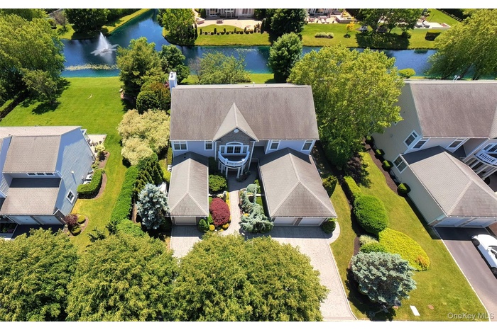 Two-story residence with a gray shingle roof, light blue siding, and white trim