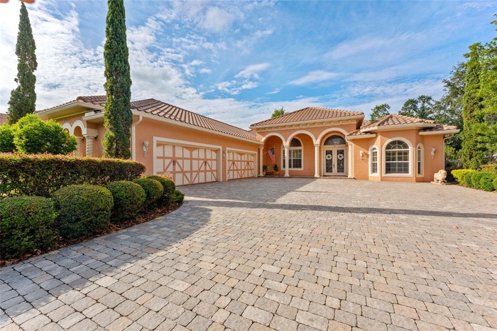 Grand paved drive and motor court and oversized 4 car garage