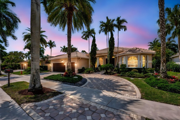 Stunning 4/3/3CG single story residence situated on a magnificent golf course lot in the heart of Weston Hills, with newer oversized lap pool and gorg