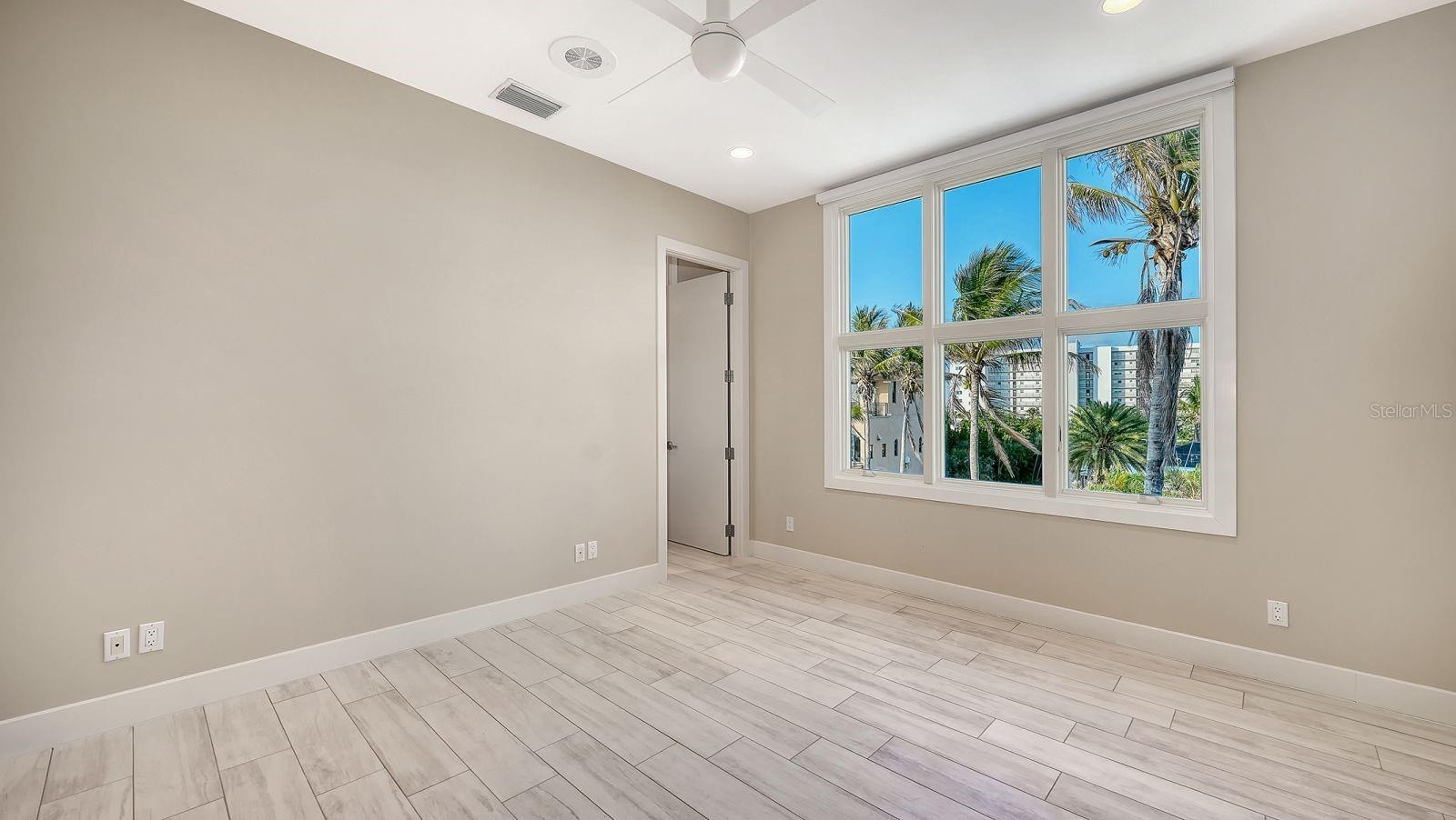 Bedroom #4 with wood plank porcelain tile floors