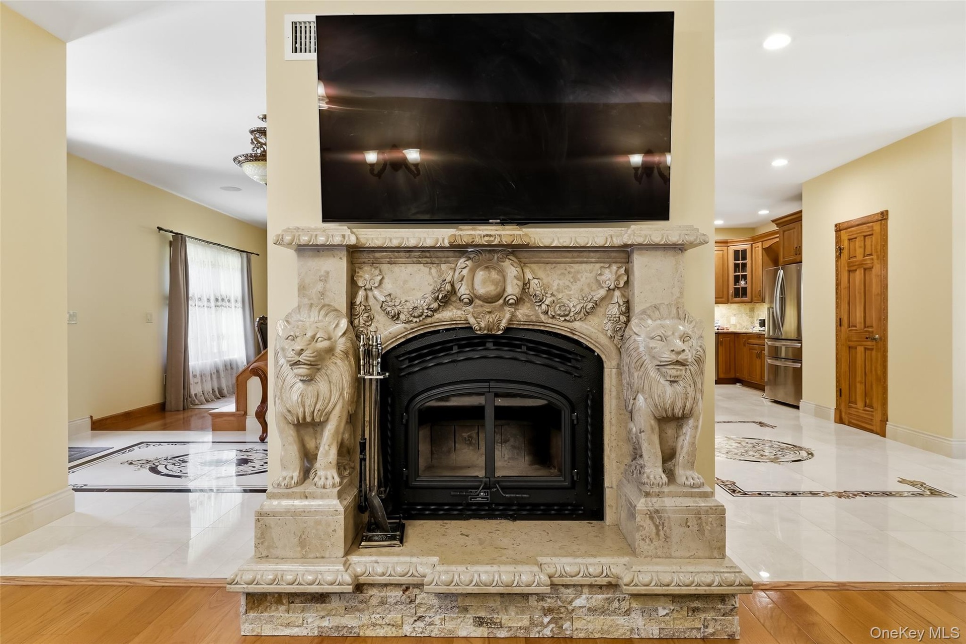 Ornate fireplace featuring carved lion figures and a stone surround with intricate detailing
