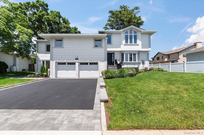 View of front of home with a garage and driveway