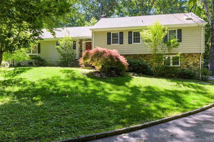 Welcome to 105 Cross Ridge Rd, walkable to Chappaqua train and village center, this renovated split ranch style home with expansive rear slate patios 