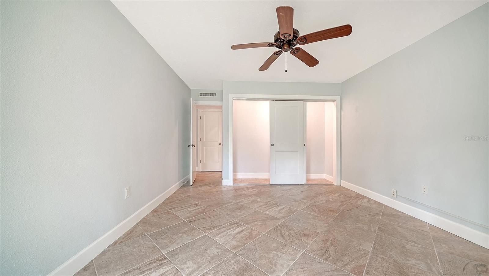 Guest bedroom with a wall of built-in closet.