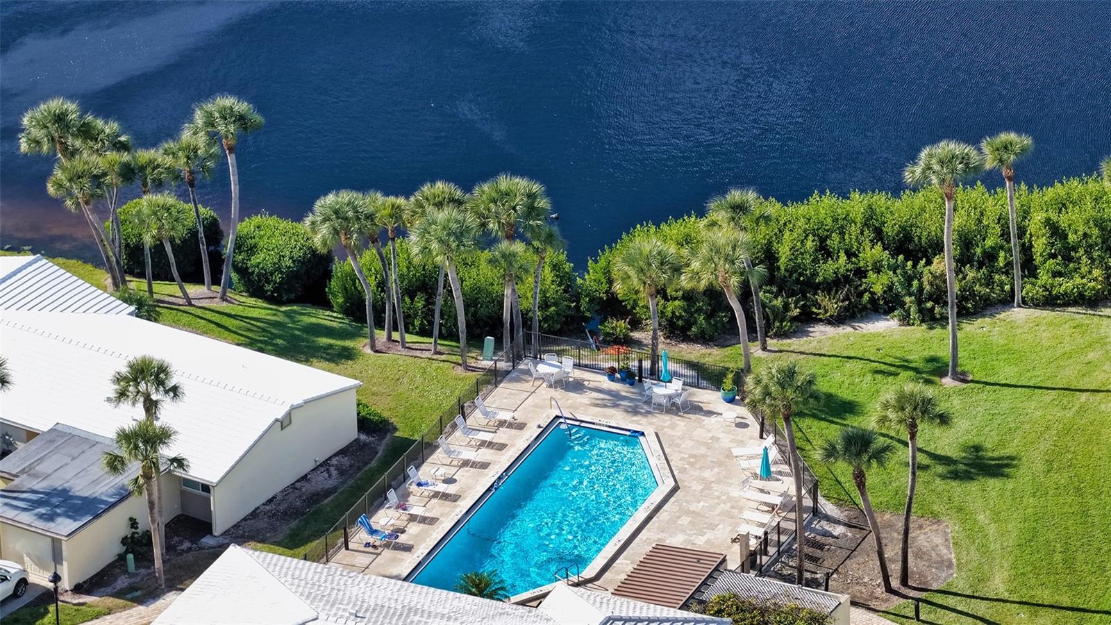 Aerial view of the beautiful clubhouse pool on the lagoon.