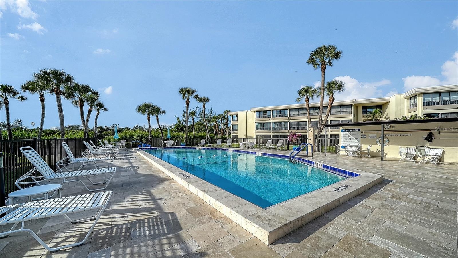 Clubhouse pool - 1 of 2 heated pools on the property.  New travertine tiled deck.