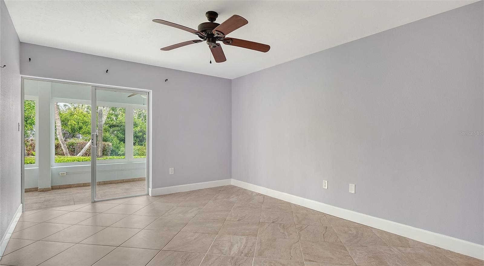 Primary bedroom with sliders leading to the lanai.