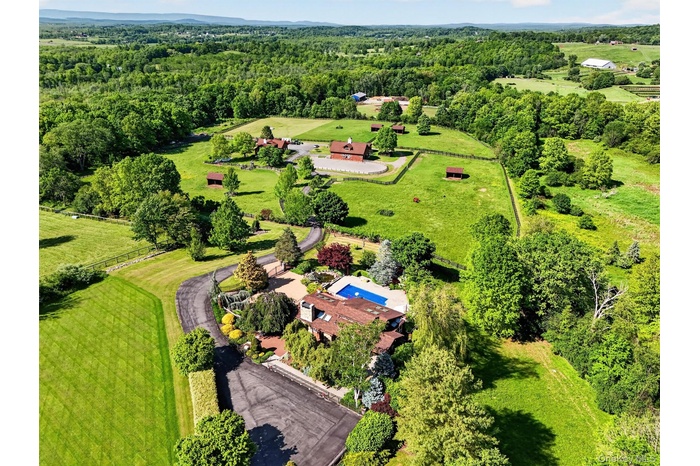 Set in a bucolic area of fine homes, the house has lovely views of the hills beyond the farm