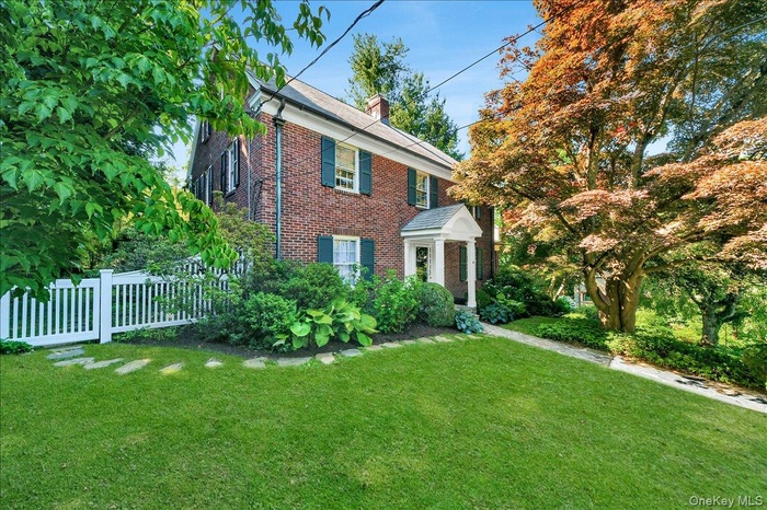 Brick exterior with white columned portico entry