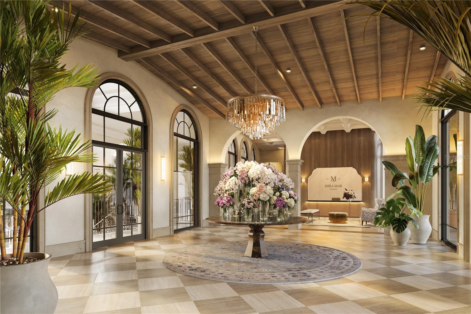 The Grand Lobby at Mira Mar offers a refined arrival experience, overlooking a beautifully landscaped courtyard and showcasing timeless architecture, 