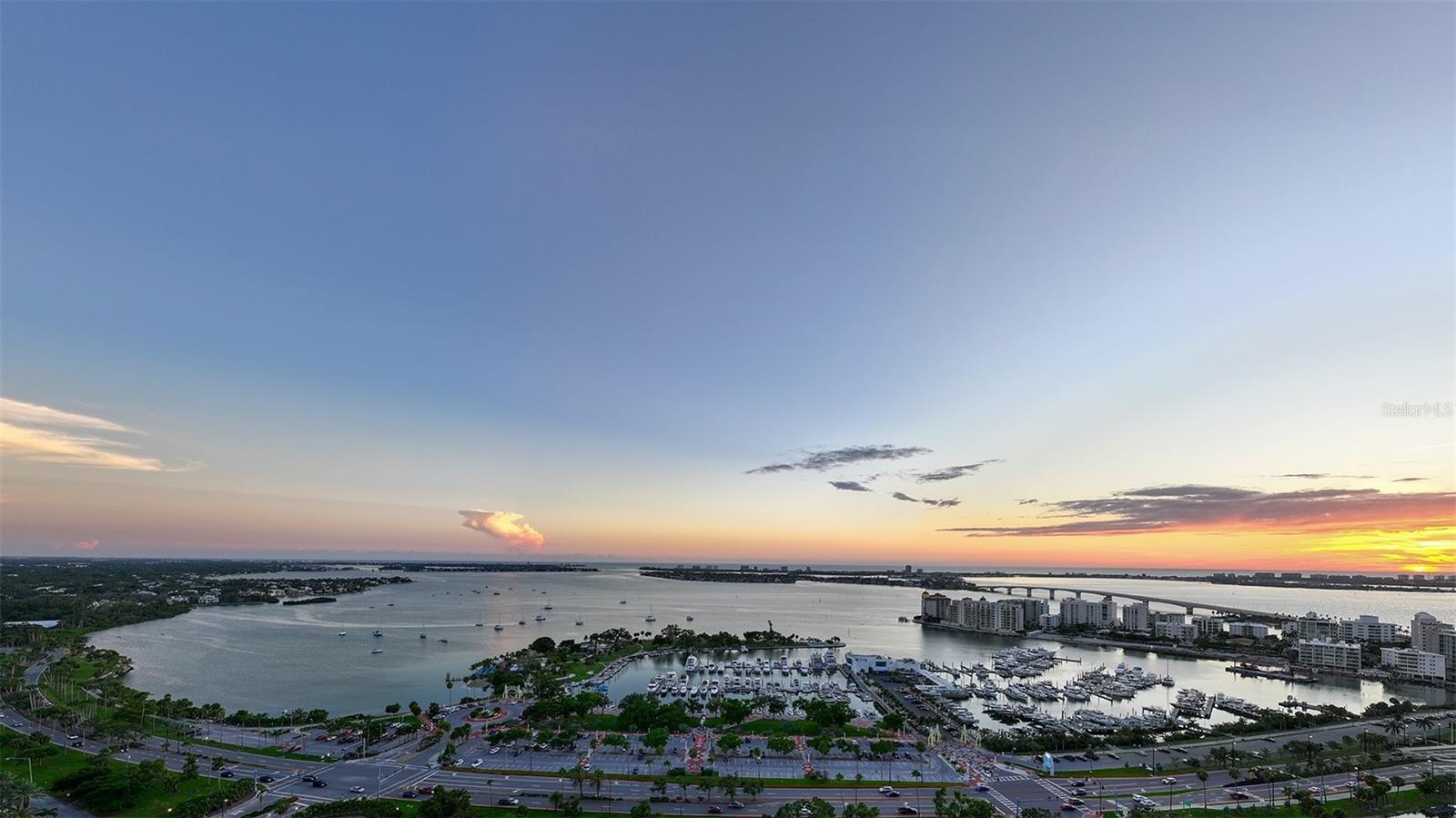 Sweeping panoramic views from the Sky Speakeasy showcase Sarasota Bay, The Gulf of Mexico, and the iconic  Ringling Bridge, creating a breathtaking ba