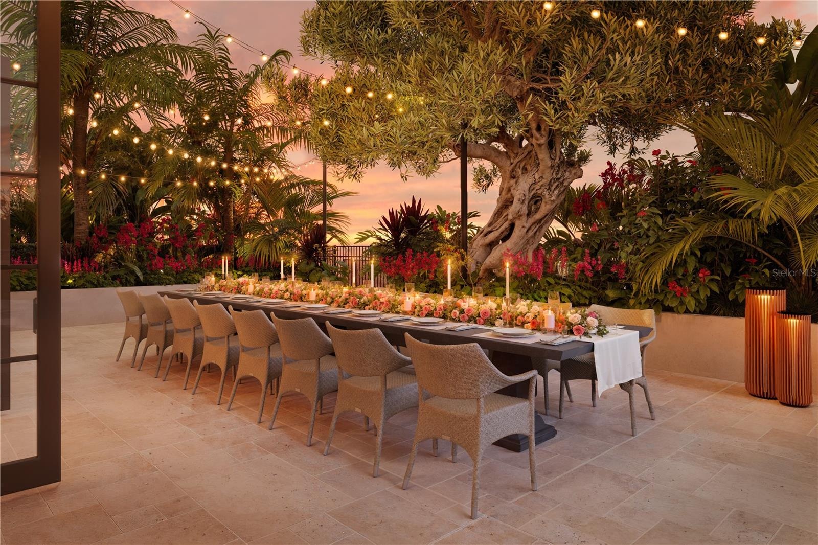 A beautifully landscaped garden terrace offers an intimate outdoor dining setting, where lush greenery and thoughtful design create a private oasis fo