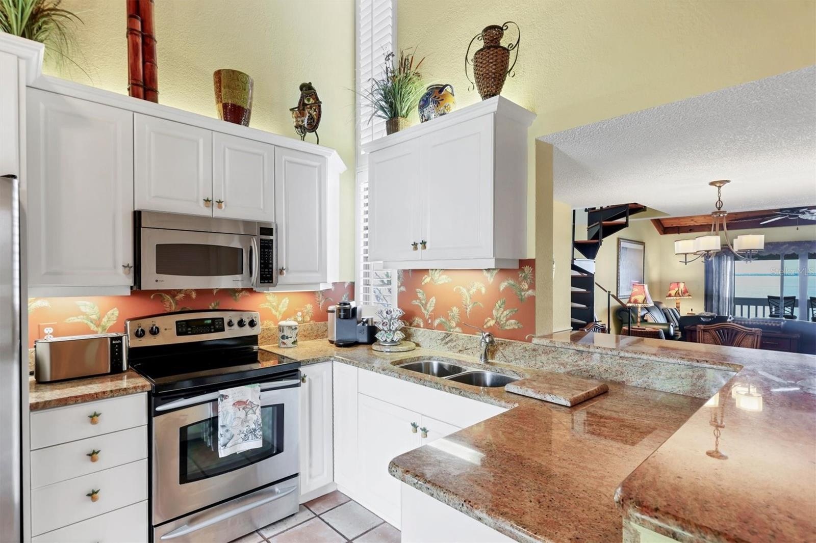 Spacious Kitchen with White Cabinetry, SS Appliances, and Granite Countertops