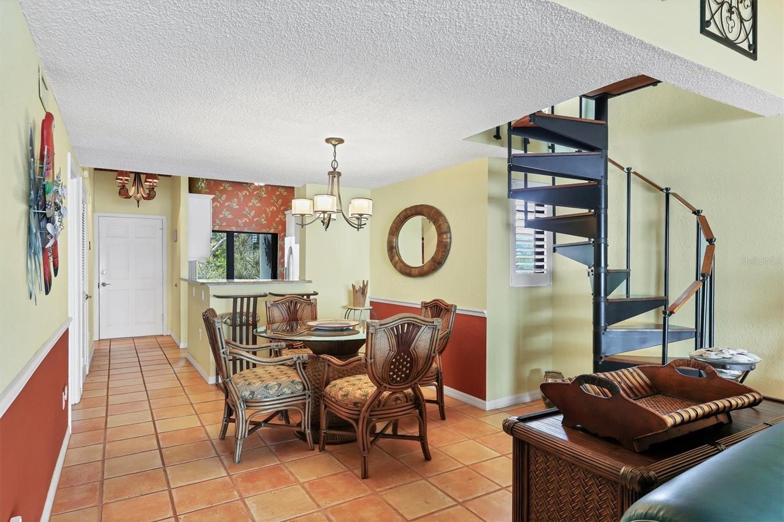 Tommy Bahama Inspired Dining Area with Spiral Stairway to Upstairs Loft & Living Quarters.