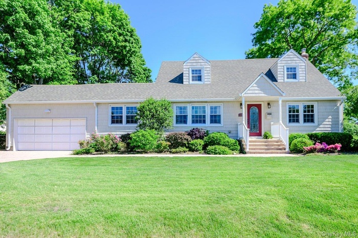 Expanded Cape Cod style home with attached two car garage.