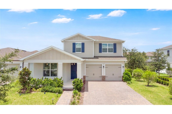 Stunning two-story home with exceptional curb appeal and a beautifully manicured front yard.