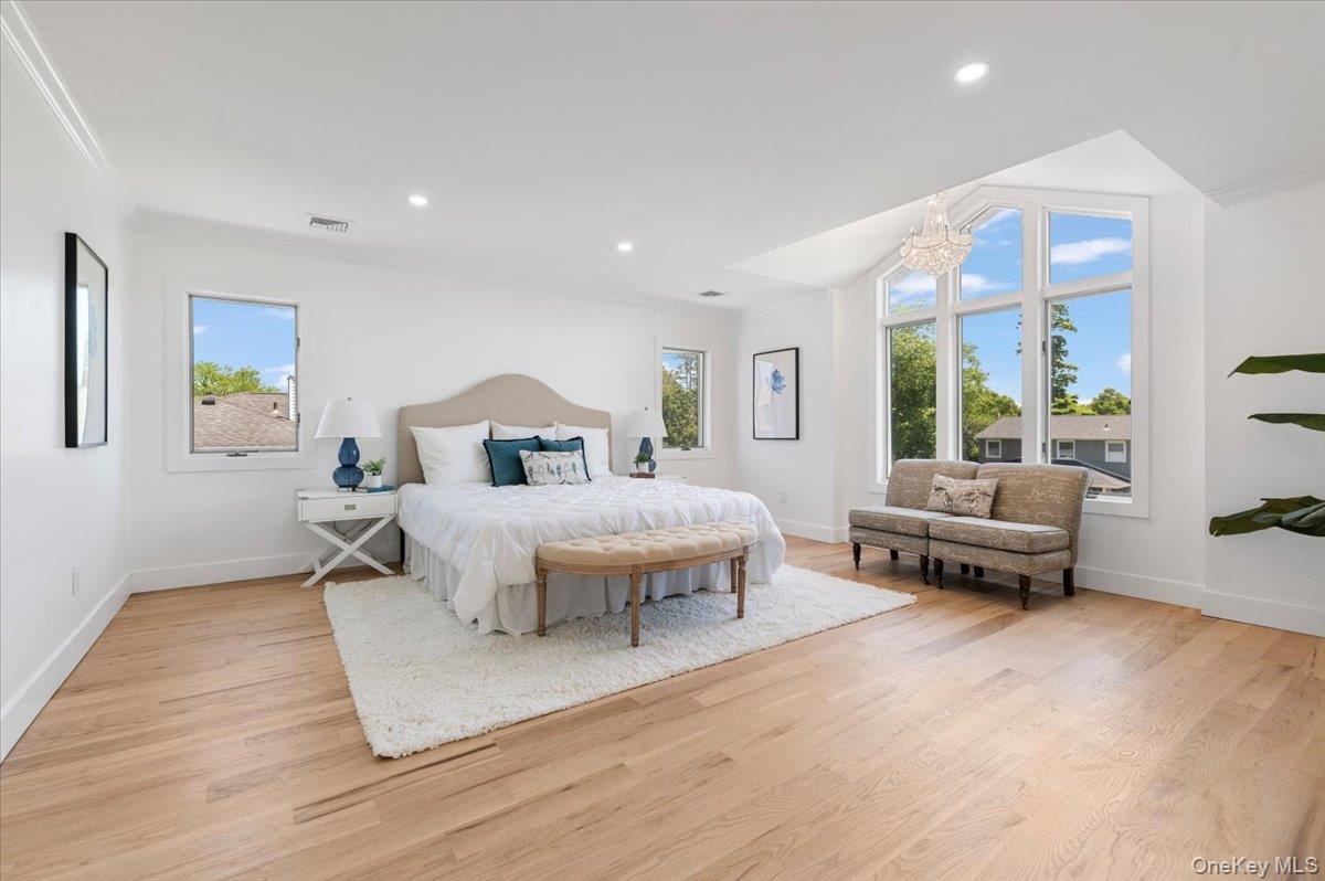 Bedroom featuring light wood-style floors, a chandelier, and recessed lighting