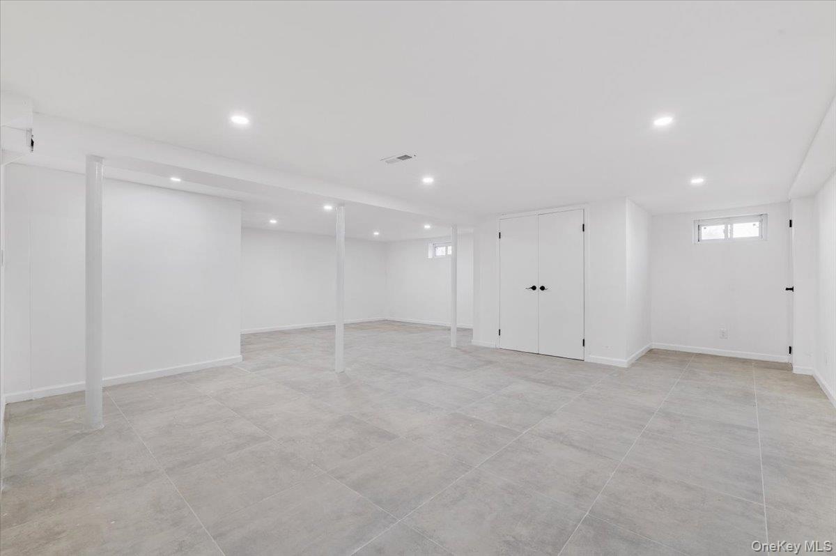 Basement featuring recessed lighting and baseboards