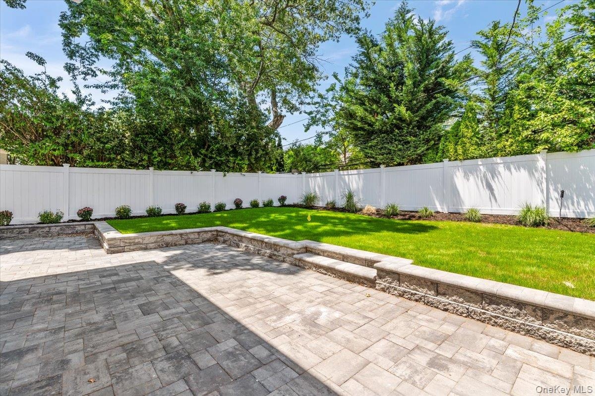 Fenced backyard featuring a patio