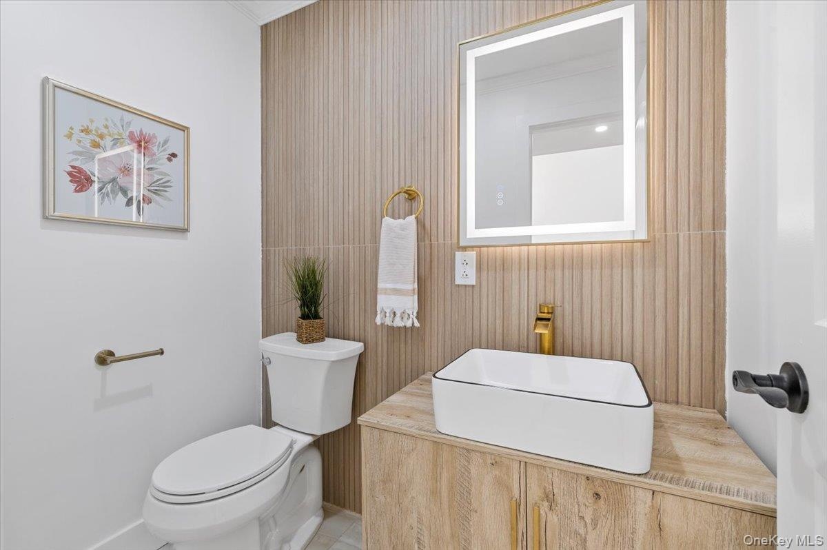 Half bathroom featuring toilet and a sink