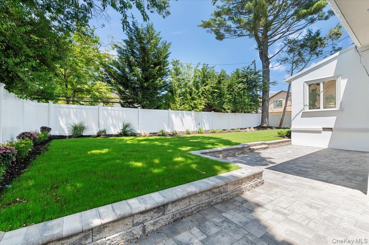 Fenced backyard with a patio