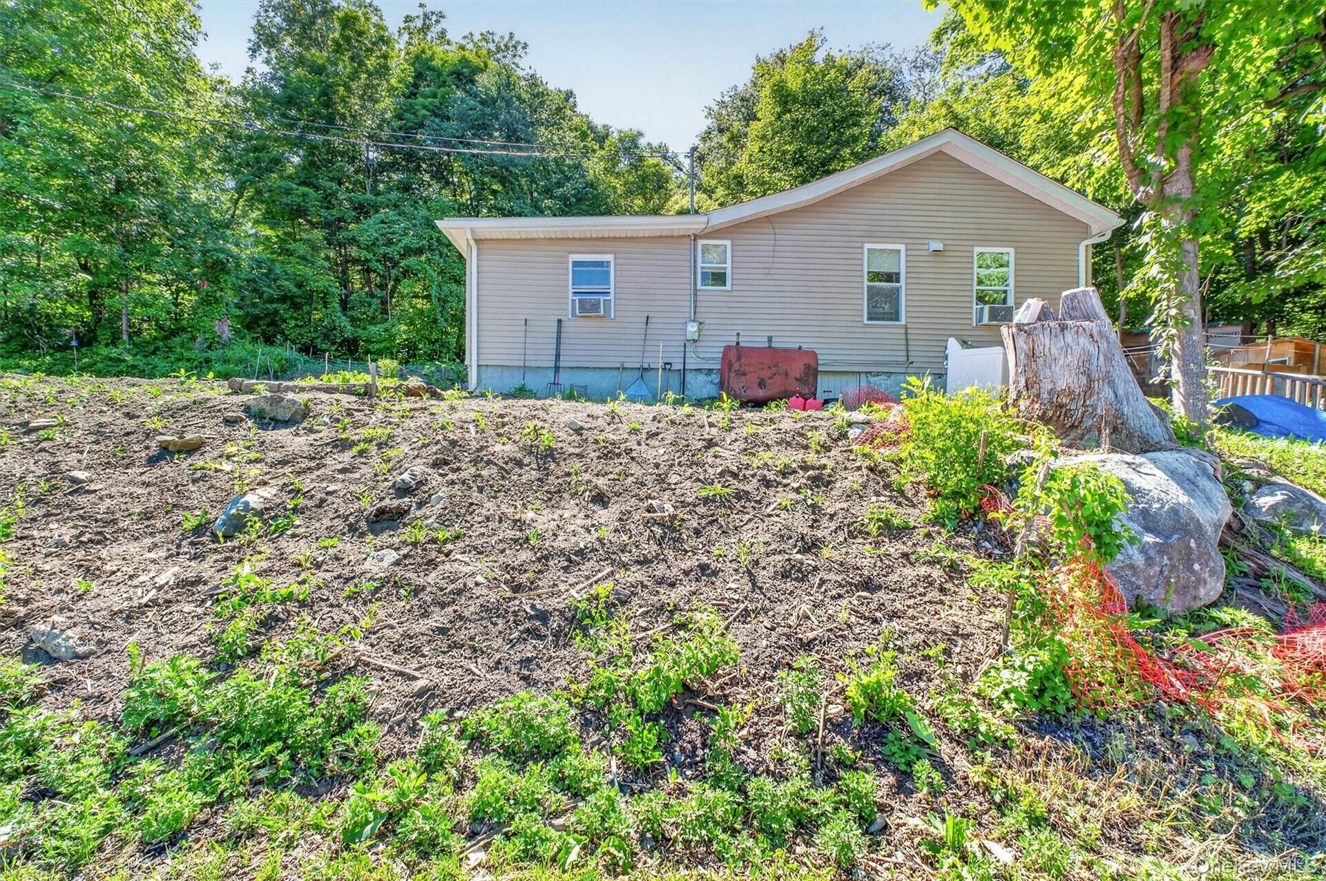 The house is set back at the end of a long driveway.