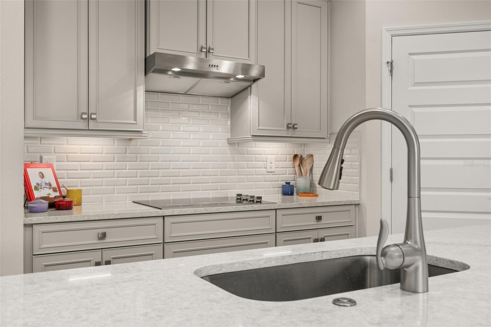 all stainless steel appliances and beautiful backsplash