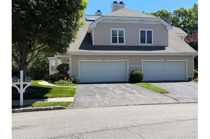 Left side is 121 exterior featuring two car garage