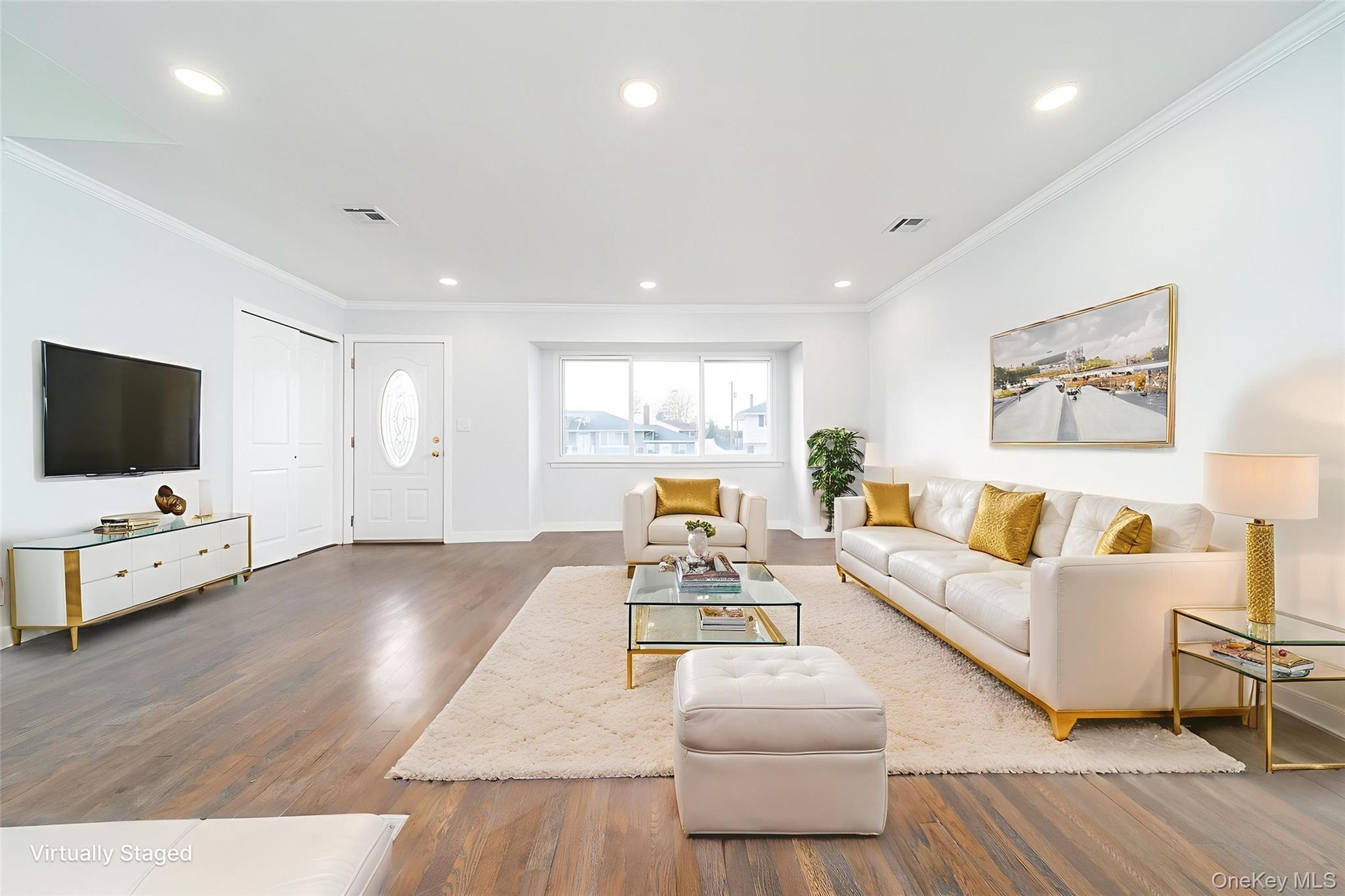 Living area with recessed lighting, wood finished floors, and ornamental molding