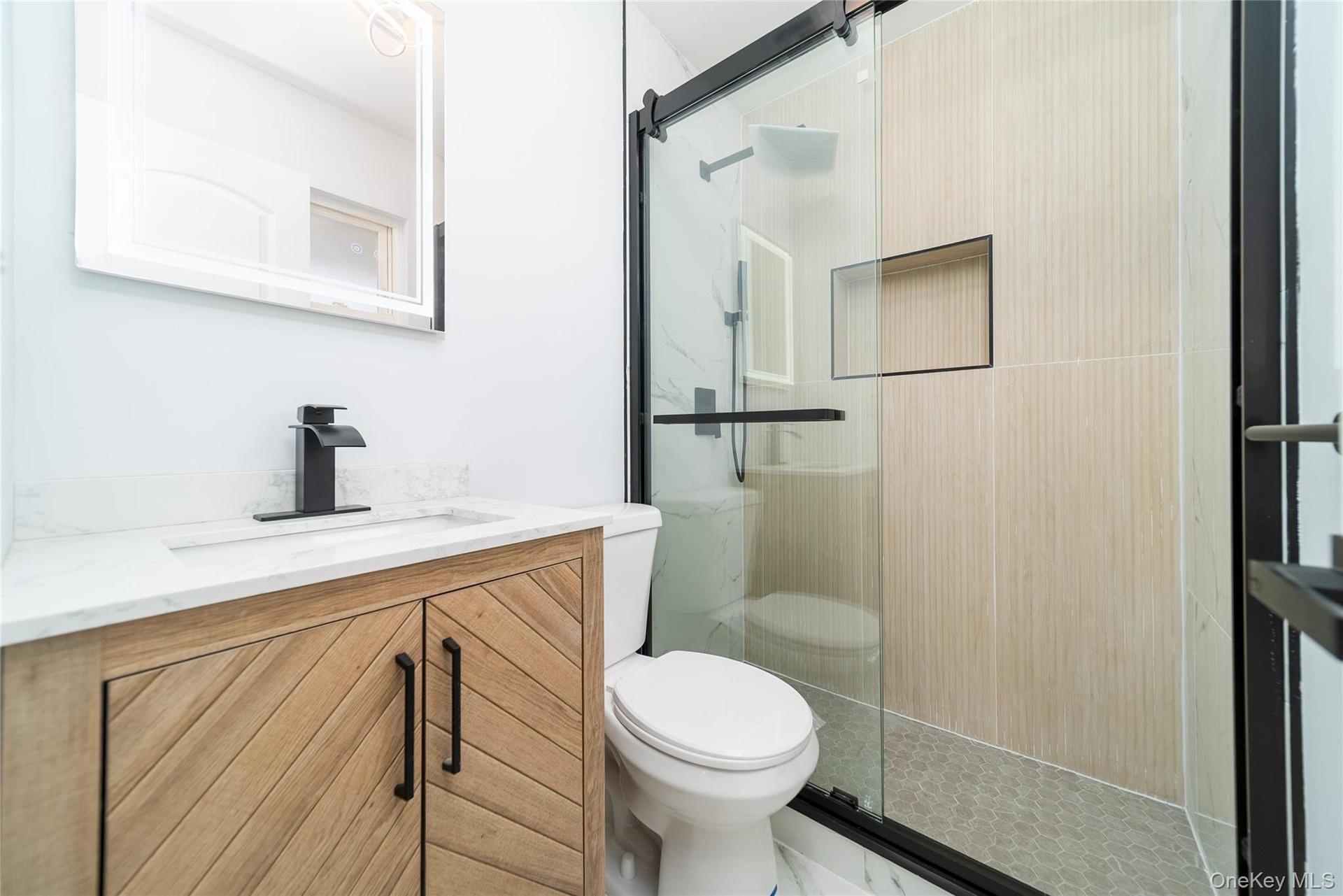 Full bathroom with vanity and a stall shower