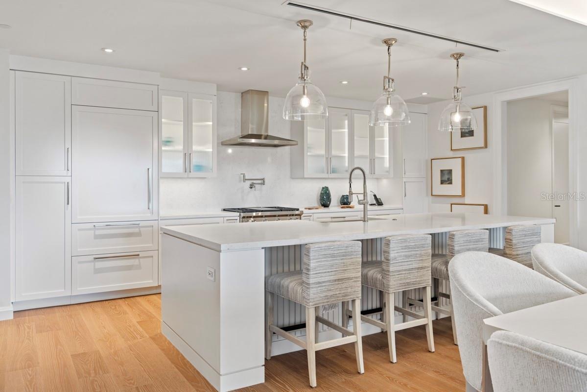 Custom frameless contemporary wood cabinetry with full-extension drawer glides, soft-close drawer and doors, complemented by under-cabinet lighting.
