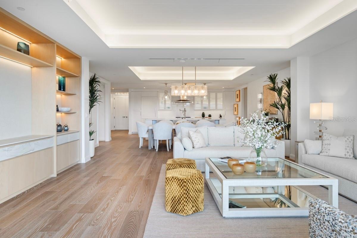 Spacious open concept living room with tongue and groove ceiling details and lighting
