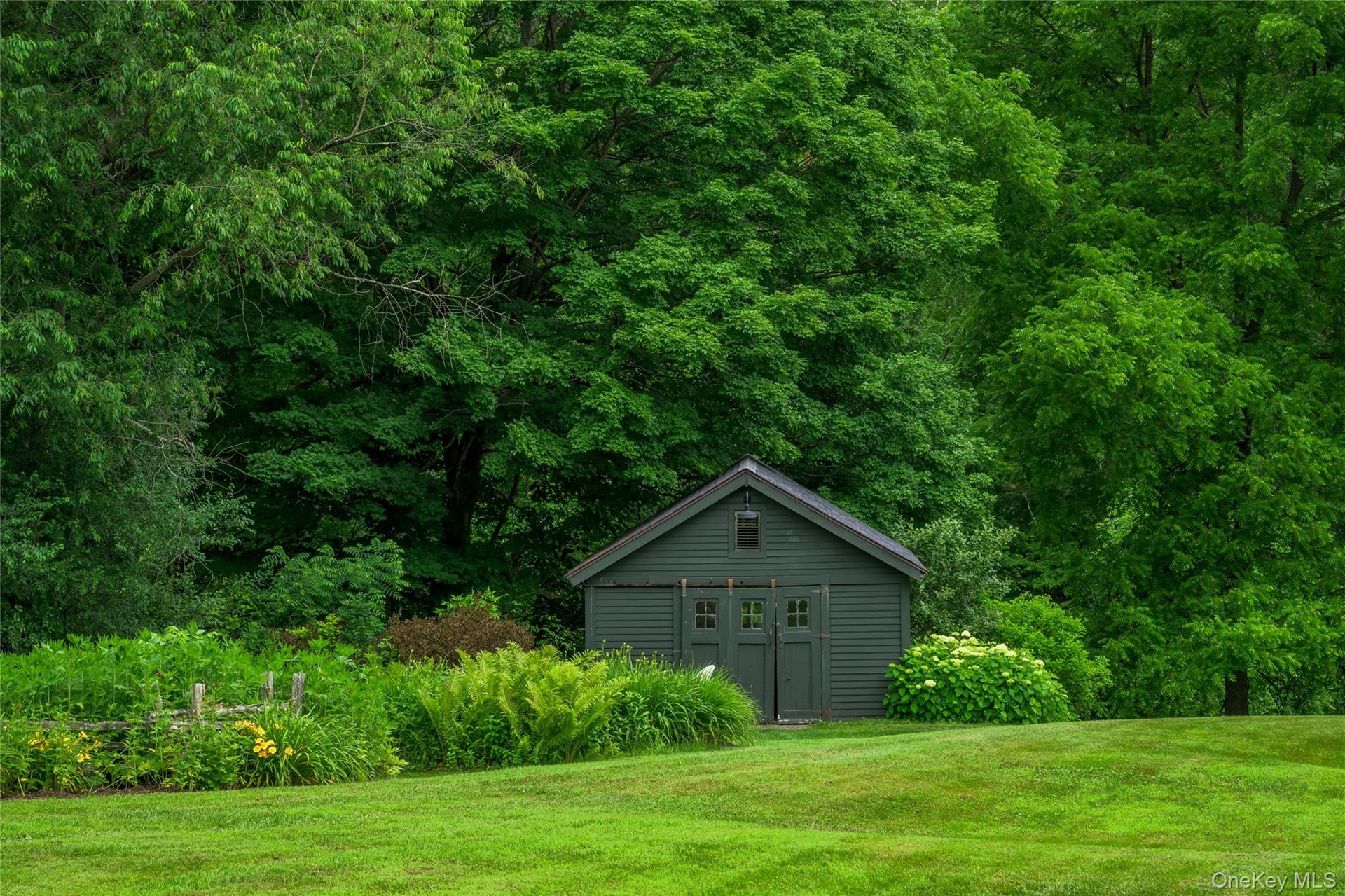 View of outbuilding with a wooded view