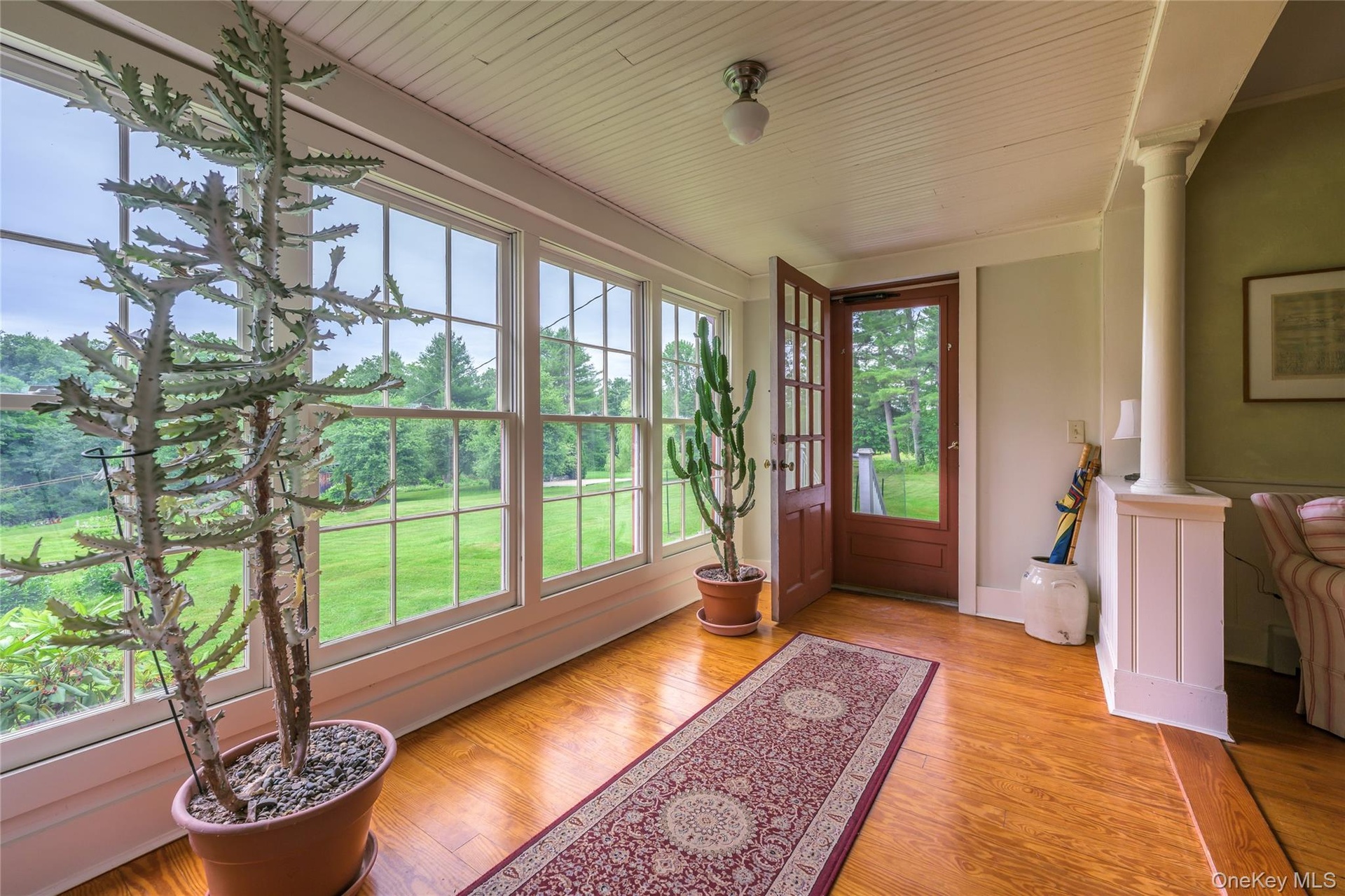 Sunroom featuring healthy amount of natural light and french doors