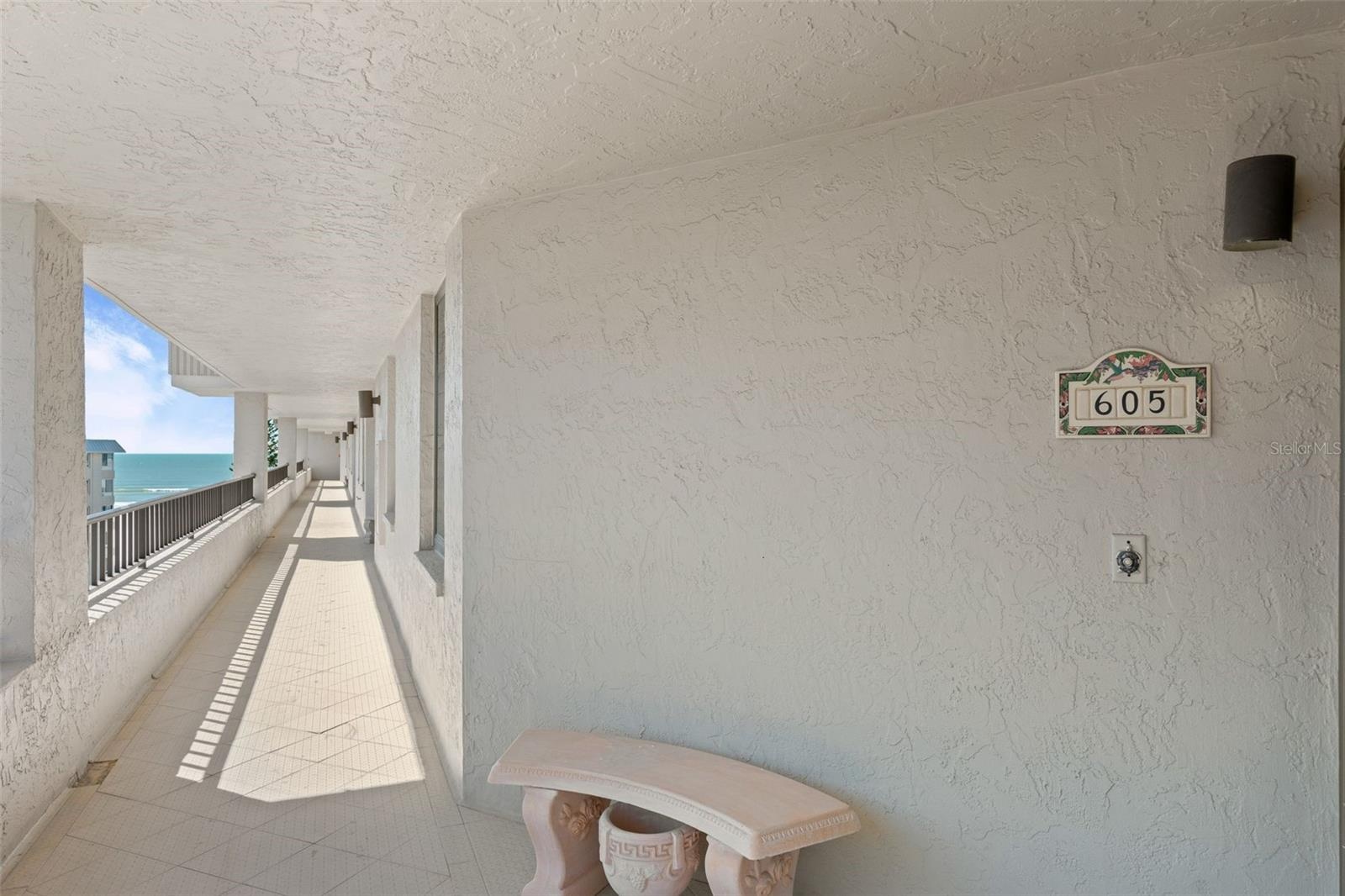 Balcony leading to door with view of the Gulf