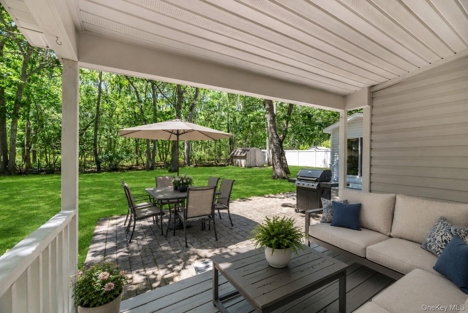 A deck and patio create inviting spaces for outdoor entertaining.