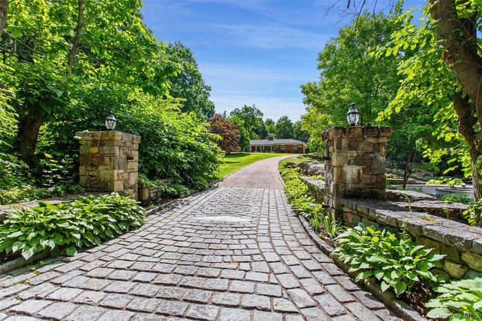 Stone driveway entrance with pillars