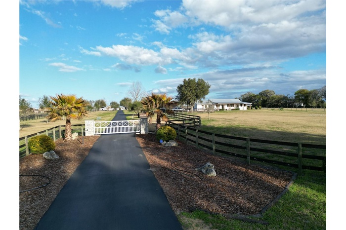 gated tree lined entry