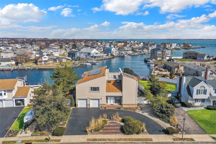 Aerial view of residential area featuring a nearby body of water