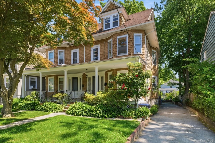 Beautifully maintained exterior surrounded by lush greenery, offering a warm first impression and inviting outdoor setting.