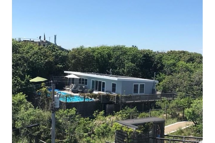 Back of property featuring a forest view