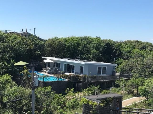 Back of property featuring a forest view