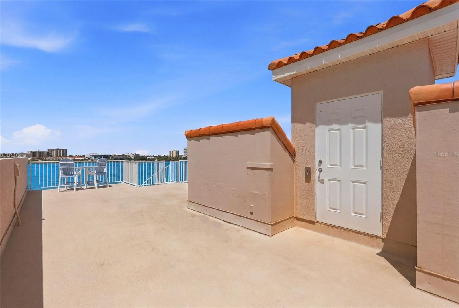 Spacious rooftop terrace with wide, open water views...absolutely lovely!!  Door is elevator entry!