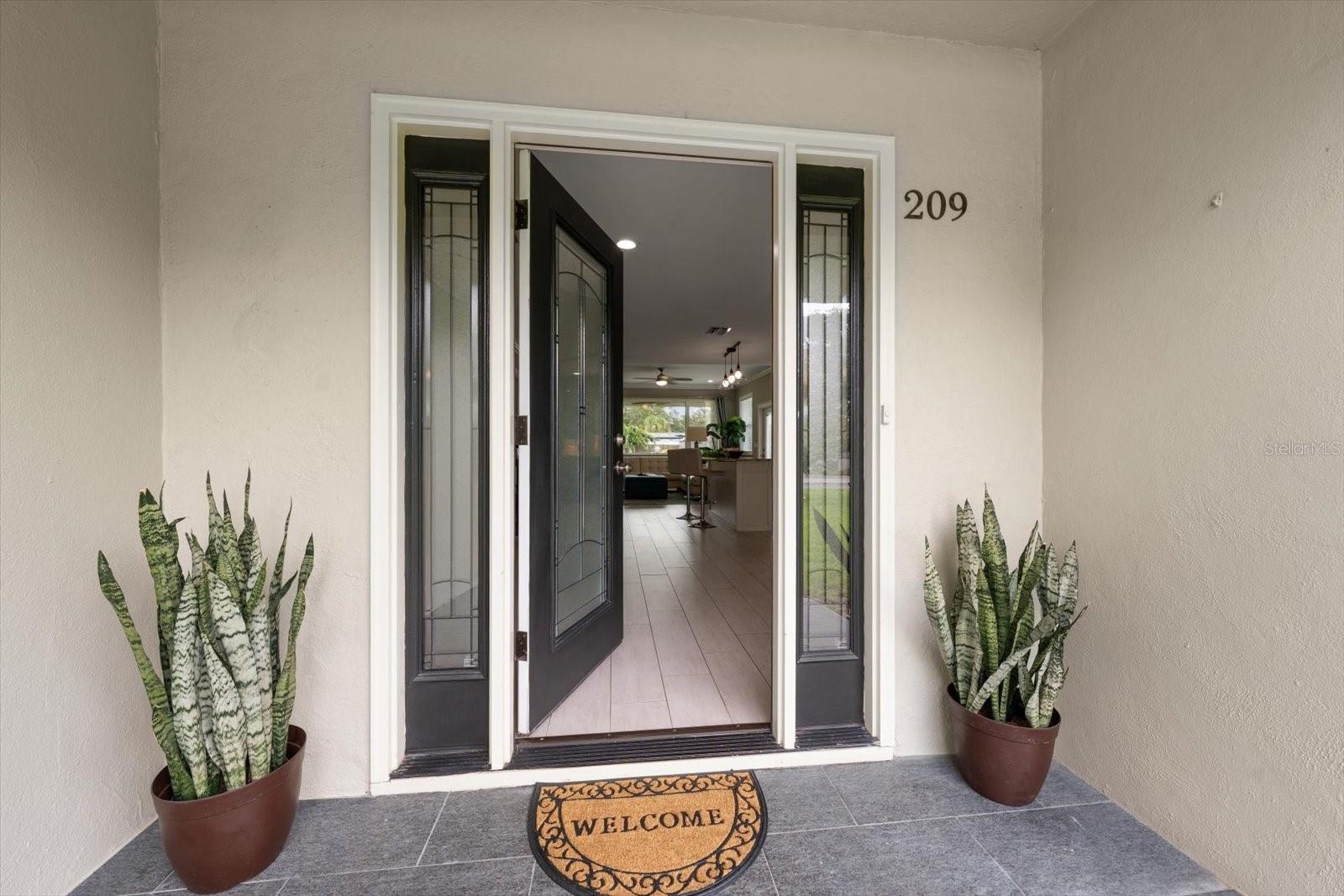 Attractive entry flanked by matching sidelights.