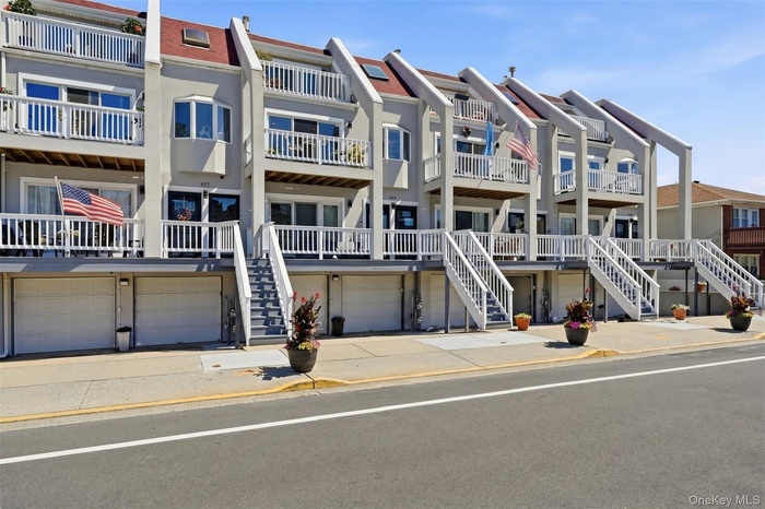 Townhouse-style condo with private entry, garage parking, driveway parking, and a prime location near the boardwalk and beach